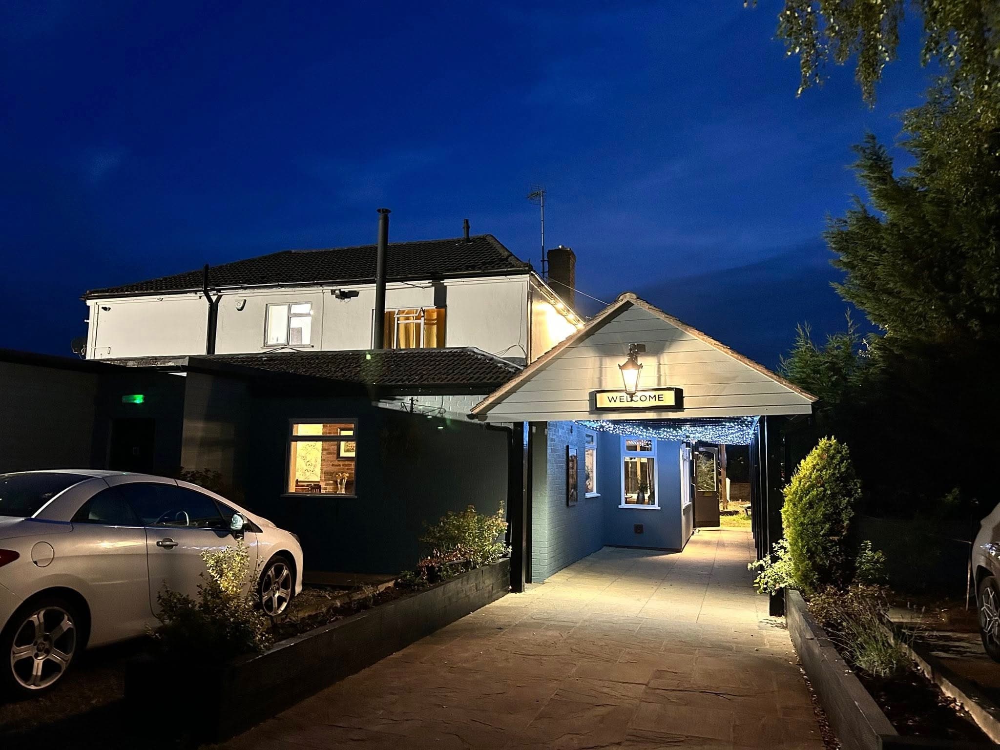 The Railway pub illuminated entrance at night